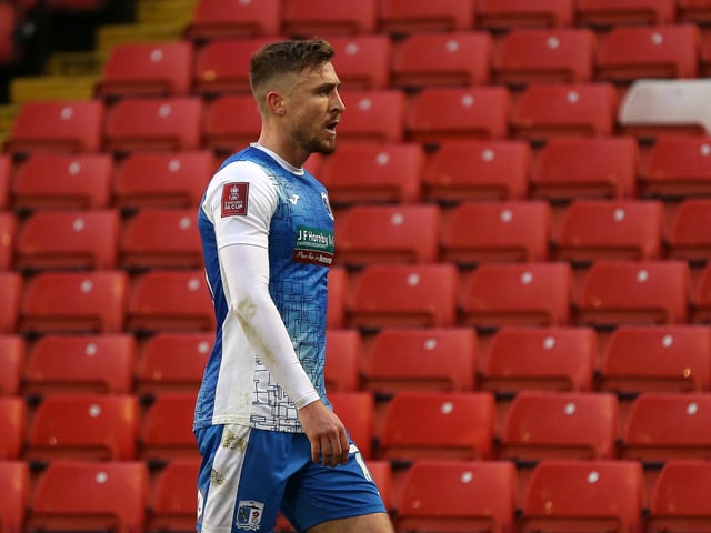 Tom Beadling of Barrow cuts a dejected figure after being shown a red card. Barrow have had 85 bookings this season and five red cads.