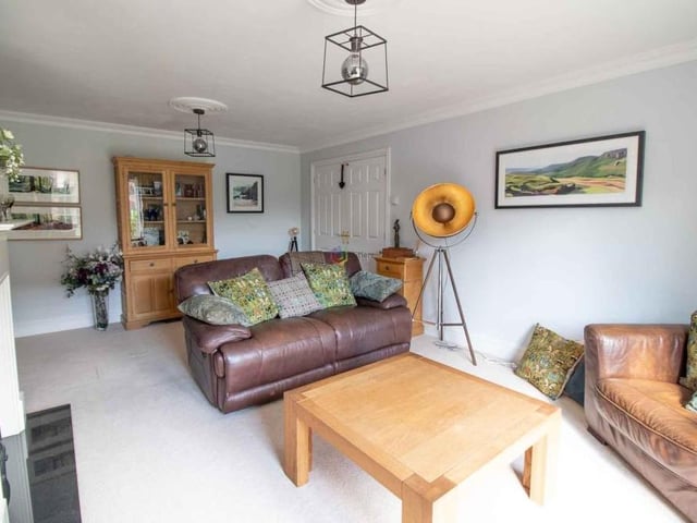 We begin our tour of the Willowbridge Lane house in this good-sized lounge, which is located at the rear of the property. It boasts a lovely, modern fireplace with an inset gas fire.
