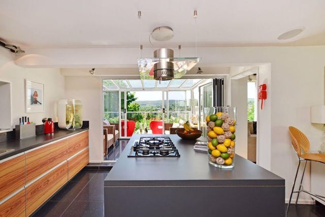 Open plan living kitchen comprising of a "beautiful fitted kitchen", with polished tiled floor flowing into both the dining area and the conservatory.