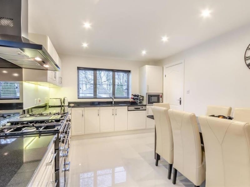 The kitchen/diner has a free-standing Rangemaster cooker with two ovens, a grill, warming drawer, six-ring gas hob and fitted extractor hood above. The room sparkles thanks to a porcelain tiled floor and eight ceiling spotlights.