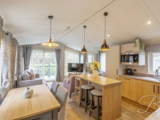 Another shot of the open-plan kitchen/dining room at the Forest Town mobile home. There are windows to three sides, making it a very bright space, and it features an inset sink with drainer.