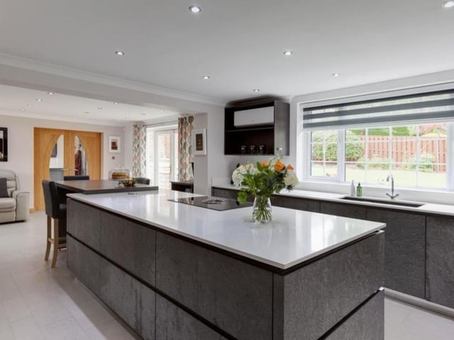 There is even an air conditioning unit in the breakfast kitchen, not to mention a coved ceiling and recessed lighting. A range of fitted base, wall and drawer units incorporate matching quartz work surfaces and an inset one-and-a-half-bowl Blanco sink with a chrome mixer tap.