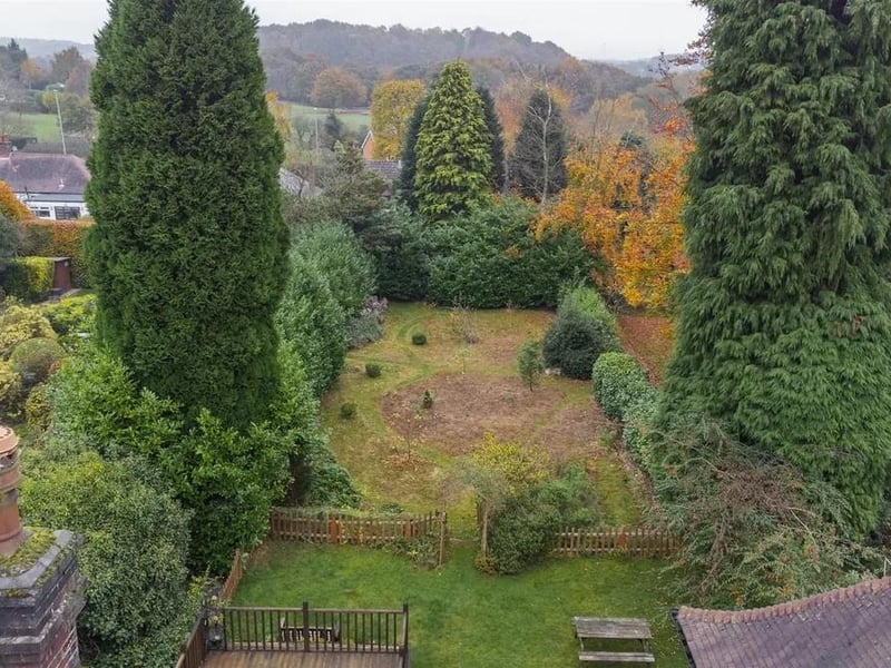 The rear garden is predominantly laid to lawn, bordered by beautiful, mature forestry that ensures a private and peaceful retreat.