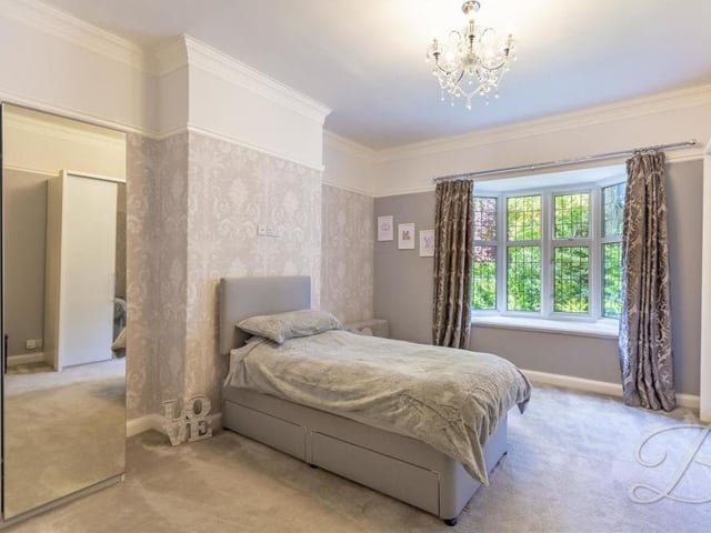 Another splendid bedroom at the High Oakham Road property. It features a carpeted floor, bay window and ample space for wardrobes and storage.