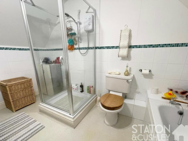 The en suite bathroom to the master bedroom is impressive. It comprises a panelled bath, shower cubicle with electric shower, pedestal sink, low-flush WC, heated towel-rail and part-tiled walls.