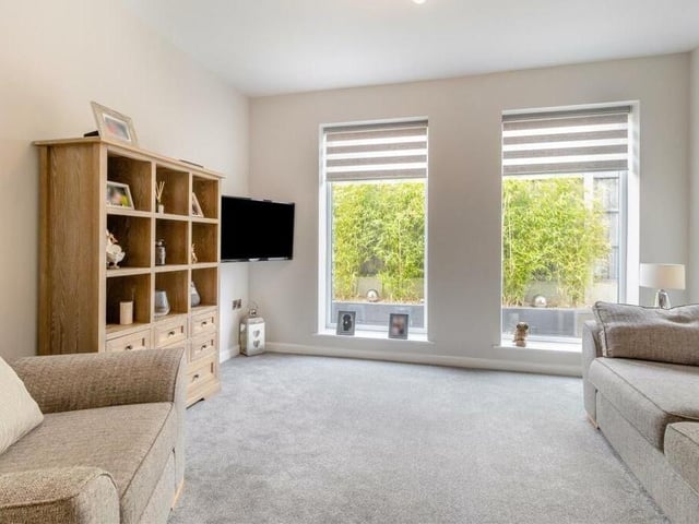 Moving on now to the bright and comfortable lounge, which includes a couple of striking, large double-glazed windows that face the side of the property.
