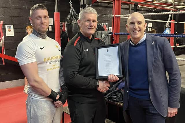 Stewart Nubley (centre) receives an award from the High Sheriff of Nottingham in recognition of his community work.