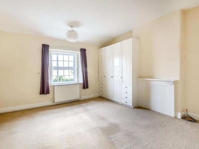The second bedroom, which is a similar size to the master, also overlooks the front of the property. It has fitted wardrobes, with hanging rails and shelving, plus separate drawers.