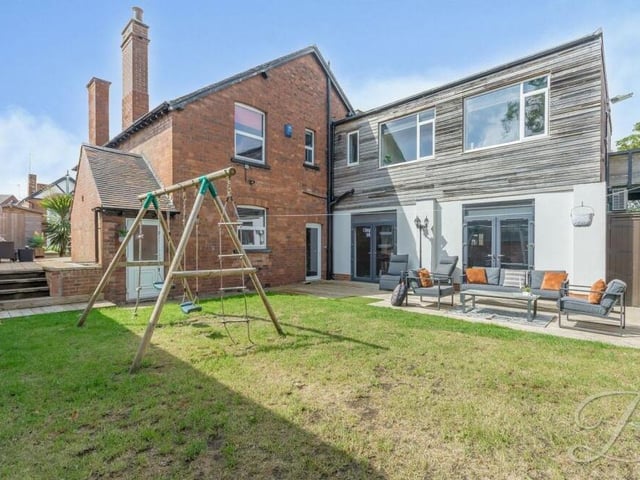 To complete our photo gallery, here are a couple of exterior shots. This is a view of the rear of the property, showing a landscaped , two-tiered garden with lawn, pathway and seating areas.
