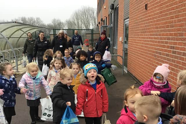 Foundation pupils handed bags full of food to the local food bank.