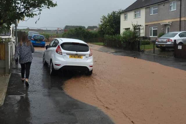 The street as water runs down from the new 'Coupe Gardens' housing development nearby. Courtesy Vinny Baker.