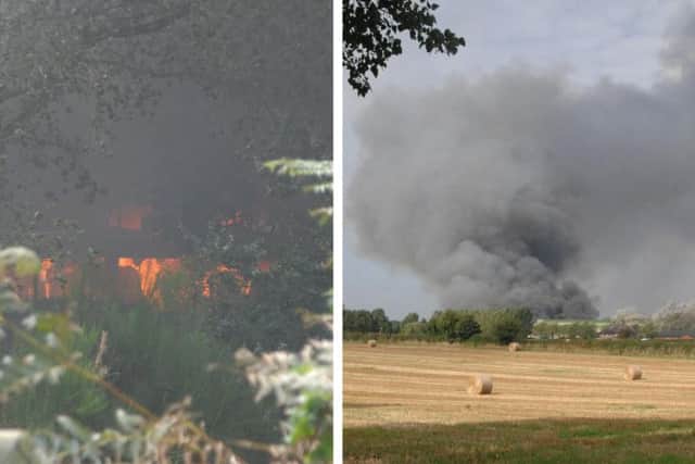 Firefighters tackle a blaze and work to prevent spreading into nearby woodland