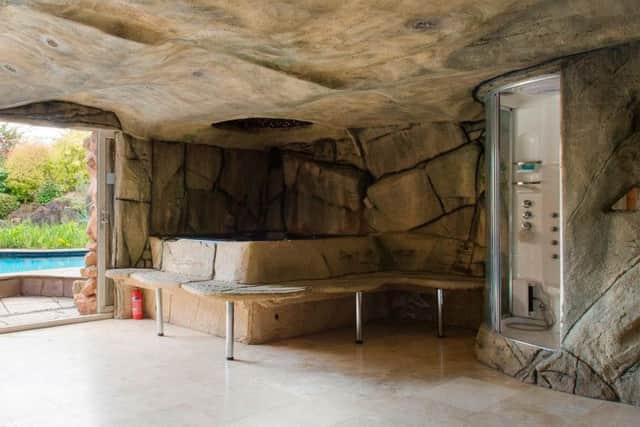 The four-bedroom house has a cave next to the pool