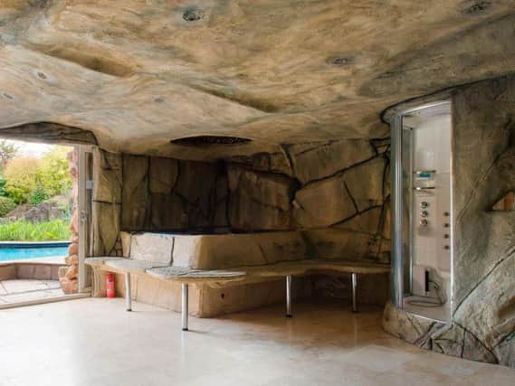 The four-bedroom house has a cave next to the pool