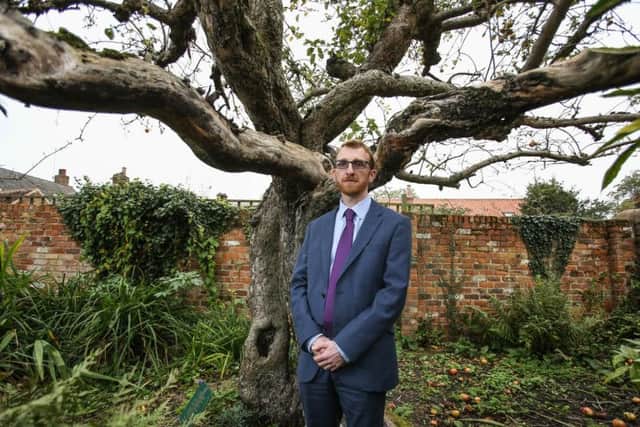 Professor Robert Mortimer with the tree. Photo - SWNS