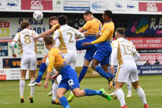 Matt Preston gets up to head at goal during the game with MK Dons.