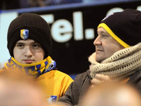 Mansfield Town fans watch their side's 1-0 win over Crawley Town last night.

Do you know anyone in this picture?