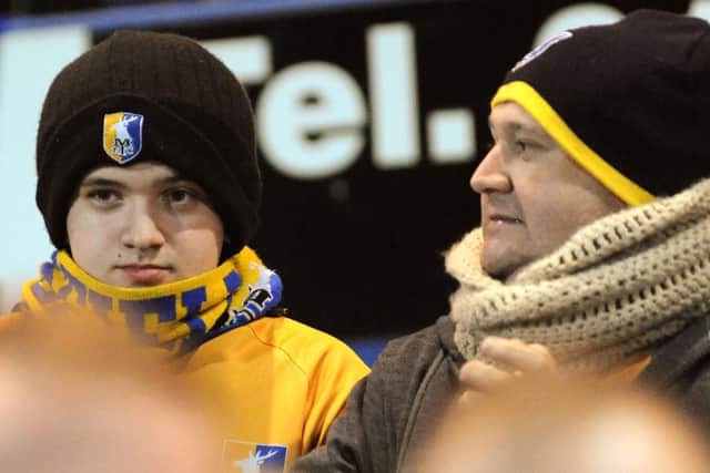 Mansfield Town fans watch their side's 1-0 win over Crawley Town last night.

Do you know anyone in this picture?