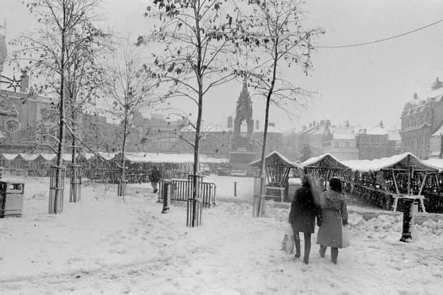 Shoppers carry on as normal during heavy snow.