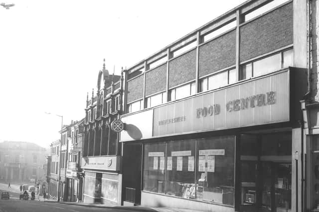 This 1972 image shows a Food Centre shop, which is now The Green Dragon, and Boots which became Dickie Dirts but is now empty.