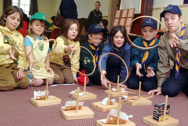 2001: Children from Edwinstowe Scouts and Guides are pictured here trying to win some sweeties while raising money for charity. Do you recognise anyone?