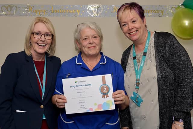 Jaqueline Ross receiving her long service award from clinical director Helen Baxendale and head of health and Safety Melanie Phillips