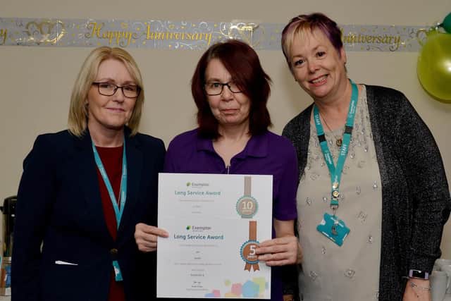 Jill Smith receiving her long service award from clinical director Helen Baxendale and head of health and safety Melanie Phillips