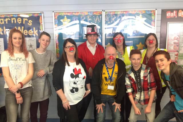 Pictured are teachers and pupils from Kirkby College, raising funds for Red Nose Day.
