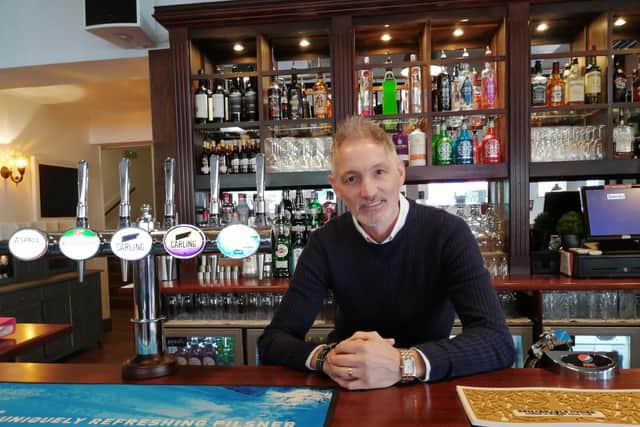 Manager John Haynes behind the bar.