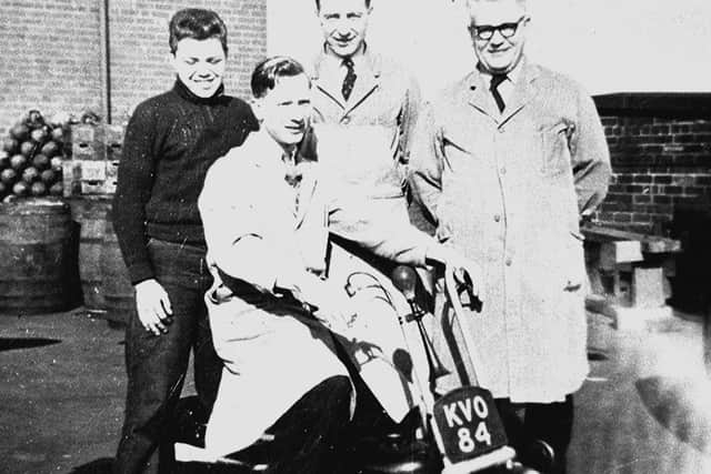 We're not sure on the date or why these men in white coats look so happy.....can you shed any light on what the motorbike was used for at the brewery?
