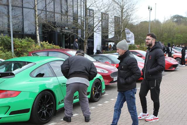 Car fans inspect a Porsche