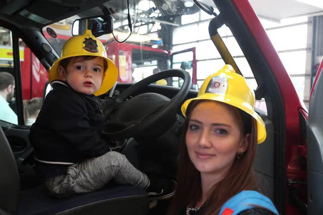 Kirsty Holmes gives son Freddie his first ride on a fire engine.