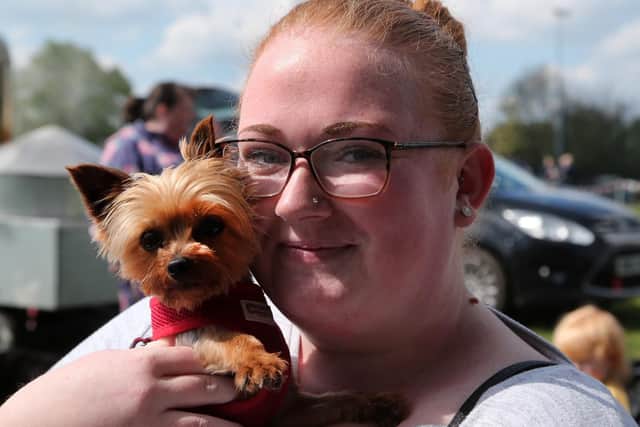 Yorkie Mia is held close by owner Sophie Hill.