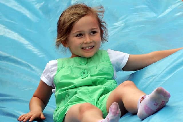 Elissa Yeomans, 6, enjoys some inflatable slide fun