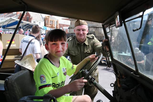 Tyler Kissane sits in the 1942 Willis jeep watched by the jeeps owner Nigel Silver.