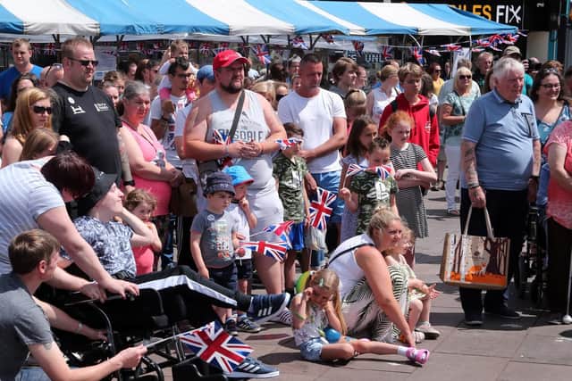 Crowds watch the Drum and bugle corp play.