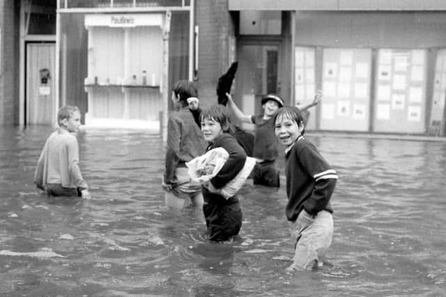 Children having fun playing in the floodwater.