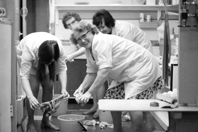 These ladies are hard at work mopping up the water but they are still smiling.