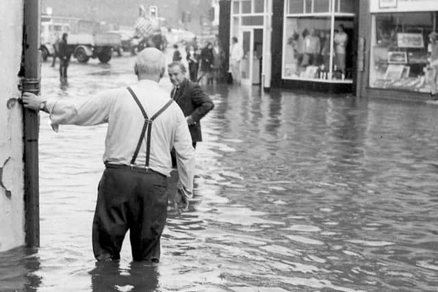 These two gents are having a chat knee-deep in water.