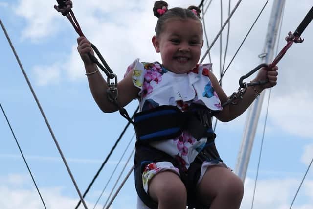 Taya Travis enjoys the trampoline ropes.