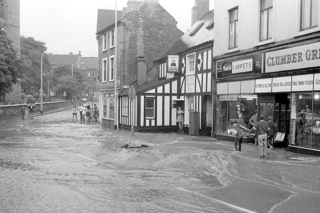 The water is flowing quite fast down this road and there seems to be a large hole forming in the road.