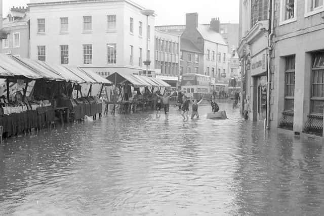 These children are making the best out of a bad situation. Notice there are market stalls open on the left.