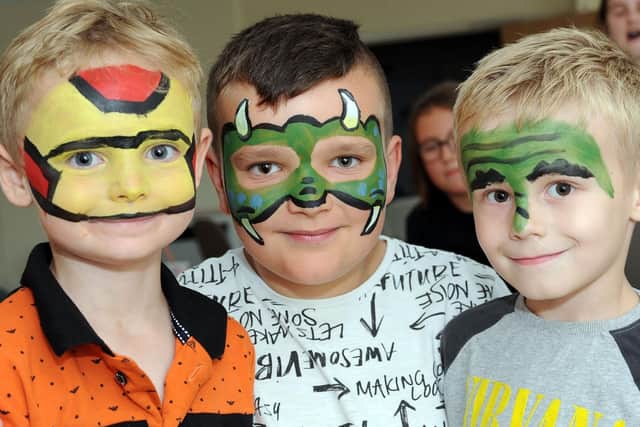 Dylan Peto, 5, Alex Smith, 11 and Theo John, 4, show off their new looks during a visit to the Youthtogether fundraiser on Saturday.