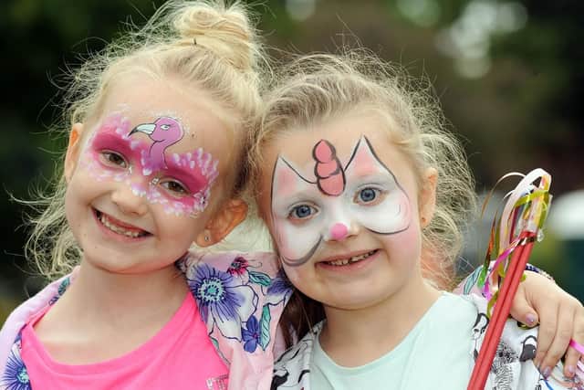 Macie Hull, 7, and her pal Isabella Marshall, 6, show off their face painting.
