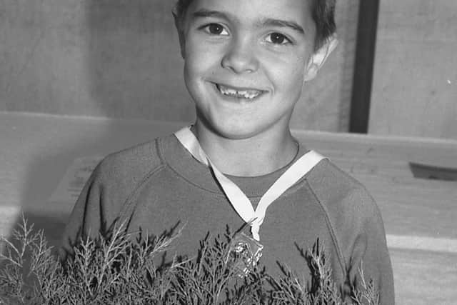 1989: This young man proudly shows off what looks like a mini garden and judging by the medal around his neck he may have won something at the Mansfield Show. Do you know what this event was?