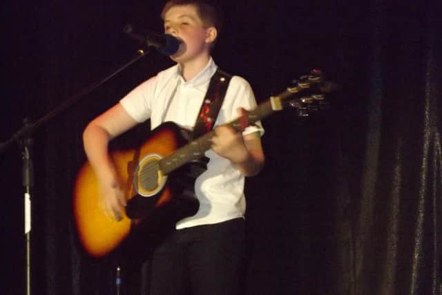 Matthew Spencer, aged 11, sings to the audience at the final