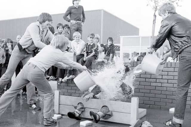 1981: Pupils from Rufford Comprehensive School in Edwinstowe gave this teacher a proper soaking at their school fair. Do you recognise anyone?