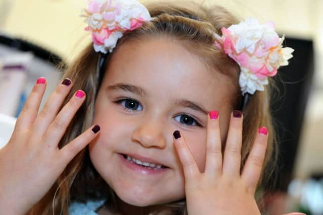Four Seasons Summer Fashion Showcase.
Jessica Robles, 5, from Forest Town, shows off her manicured nails when she stopped off at the beauty station during Saturday's 'summer-sational' event.