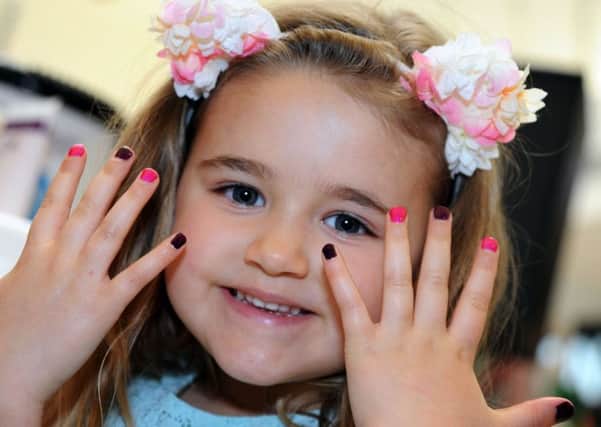 Four Seasons Summer Fashion Showcase.
Jessica Robles, 5, from Forest Town, shows off her manicured nails when she stopped off at the beauty station during Saturday's 'summer-sational' event.