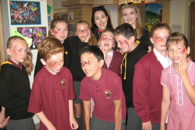 Mock cuts and brusies, prepared by make-up artist Nicola Comer, are sported by these youngsters.
